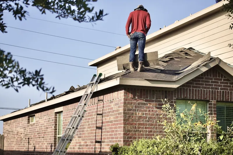 Professional roofer working on a residential roof in Lapeer